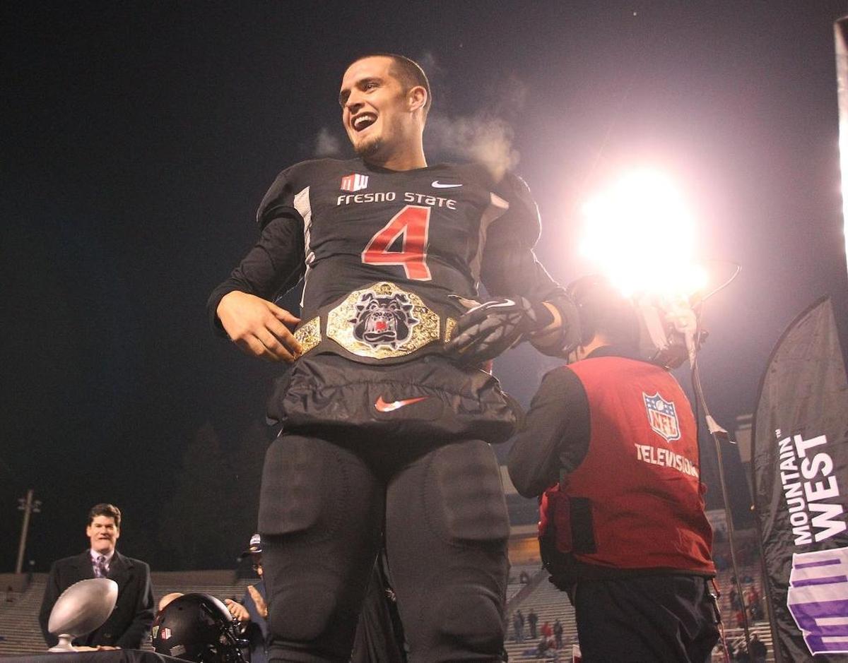 Fresno State quarterback Derek Carr celebrates a Mountain West Conference title in his last game at Bulldog Stadium, Dec. 7, 2013.