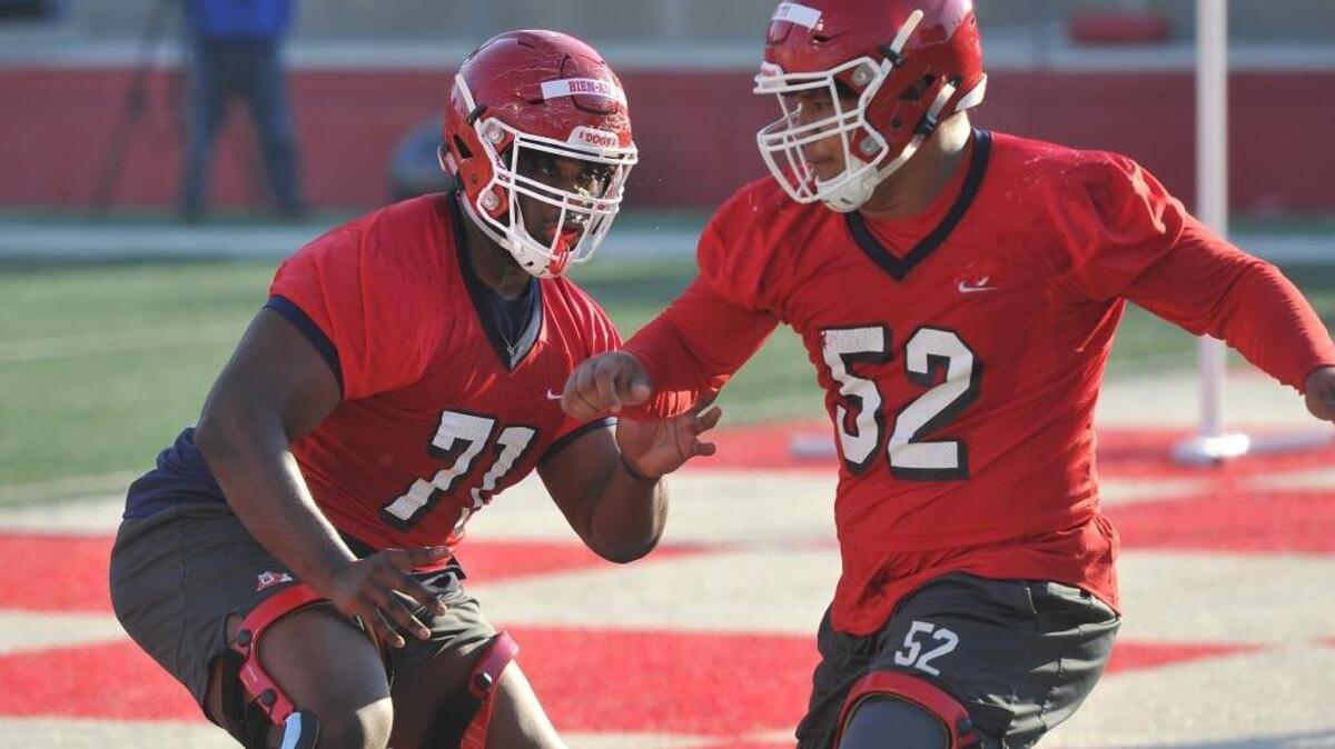 Fresno State offensive linemen Marc-David Bien-Amie, left, and Netane Muti run a drill during the first spring practice, Monday morning, March 12, 2018. Bien-Amie has moved to right tackle from right guard in fall camp, a move line coach Ryan Grubb said better fits the 6-foot-5, 350-pound freshman.