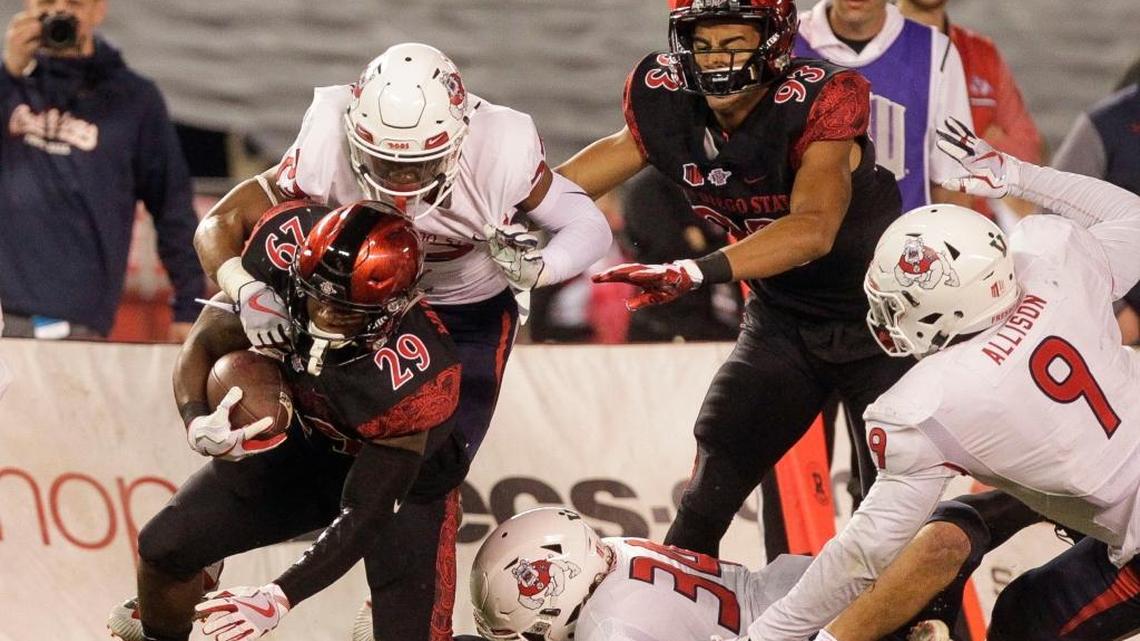 Fresno State’s Juju Hughes tackles San Diego State’s Juwan Washington during the first quarter Saturday, Oct. 21, 2017, at SDCCU Stadium in San Diego. Hughes and the Bulldogs held the Aztecs to 255 total yards in a 27-3 victory.