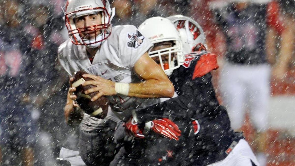Fresno State linebacker Justin Green, right, sacks UNLV quarterback Kurt Palandech, left, to preserve the Bulldogs’ 31-28 victory as a deluge falls Friday, Oct 16, 2015 in Fresno, Calif. Green is No. 1 on the depth chart at Sam linebacker, a position that took a hit with a season-ending injury to Kesomi Mafi.