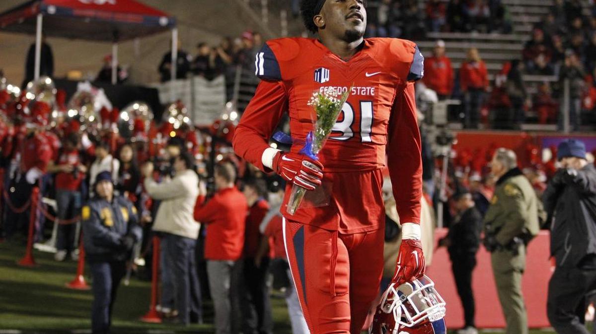 Fresno State’s Ejiro Ederaine carries a rose during senior night festivities before the Bulldogs’ game against Colorado State on Saturday, Nov. 28, 2015. The linebacker on Tuesday was named to the 2015 All-Mountain West second team.