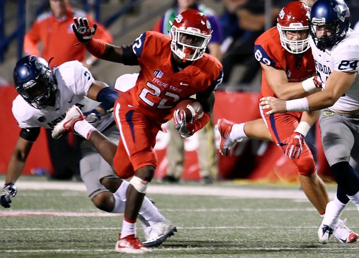 Fresno State freshman Jordan Mims cuts away from Nevada’s Asauni Rufus, left, in the Bulldogs’ 41-21 victory over the Wolf Pack Saturday, Sept. 30, 2017 in Fresno. Mims is leading the Bulldogs in rushing with 512 yards. He is averaging 4.5 yards per play.