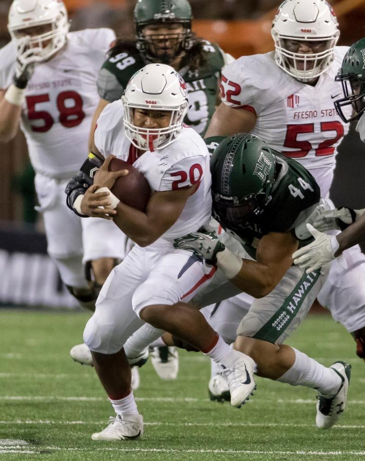Fresno State running back Ronnie Rivers (20) protects the football as he is taken down by Hawaii linebacker Russell Williams Jr. (44) during the second quarter of the Bulldogs’ 31-21 victory, Saturday, Nov. 11, 2017, in Honolulu.