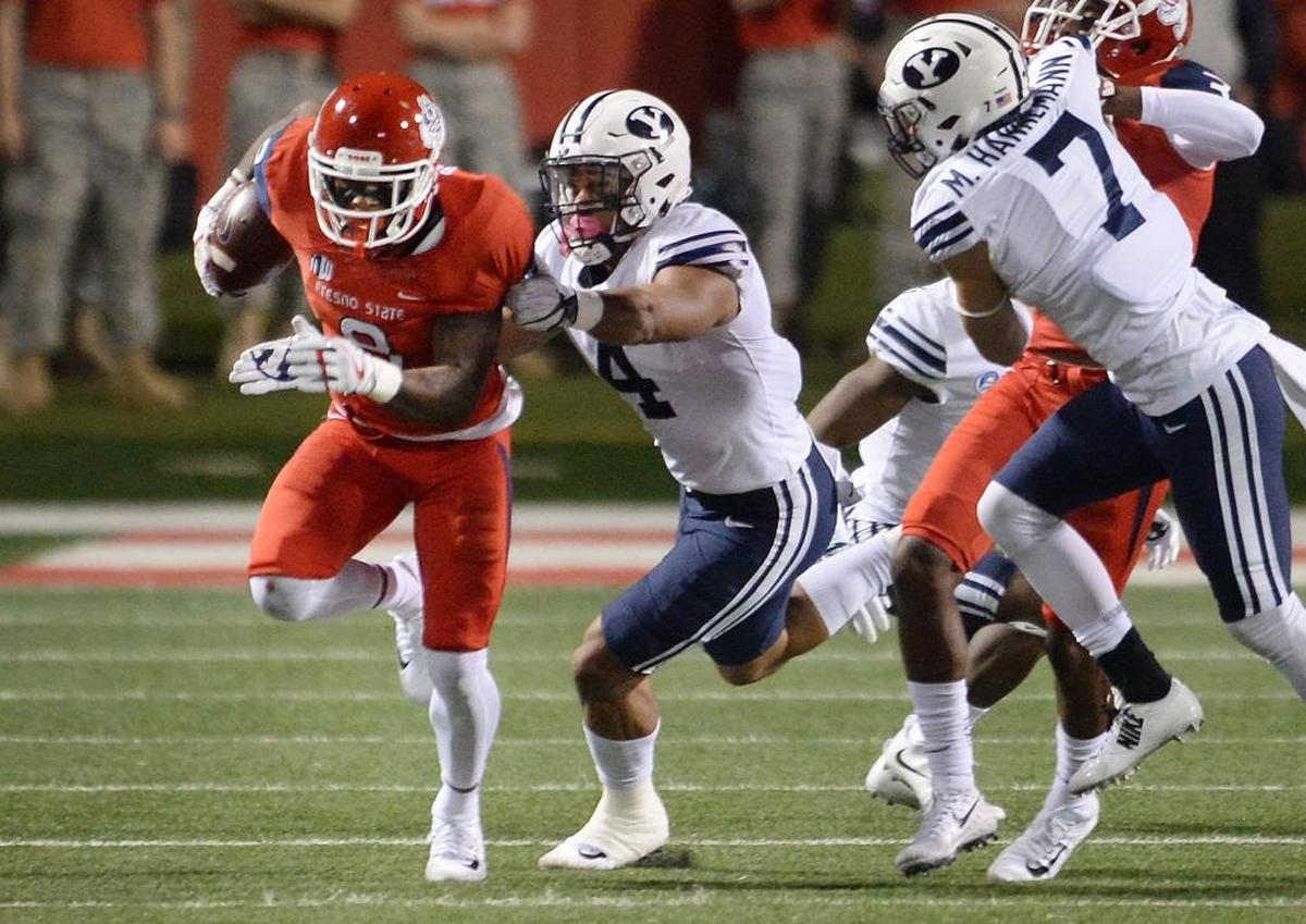 Fresno State wideout Da’Mari Scott, left, turns up field after making a catch near the sideline while defended by BYU’s Fred Warner during a 229-13 victory game at Bulldog Stadium on Saturday, Nov. 4, 2017. The victory was the sixth for Fresno State, making the Bulldogs bowl-eligible after going 1-11 last season.