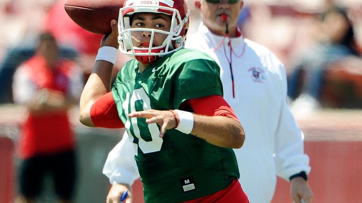 Fresno State quarterback Jorge Reyna passes under the eye of coach Jeff Tedford, background, on Saturday, April 29, 2017 in Fresno, Calif.