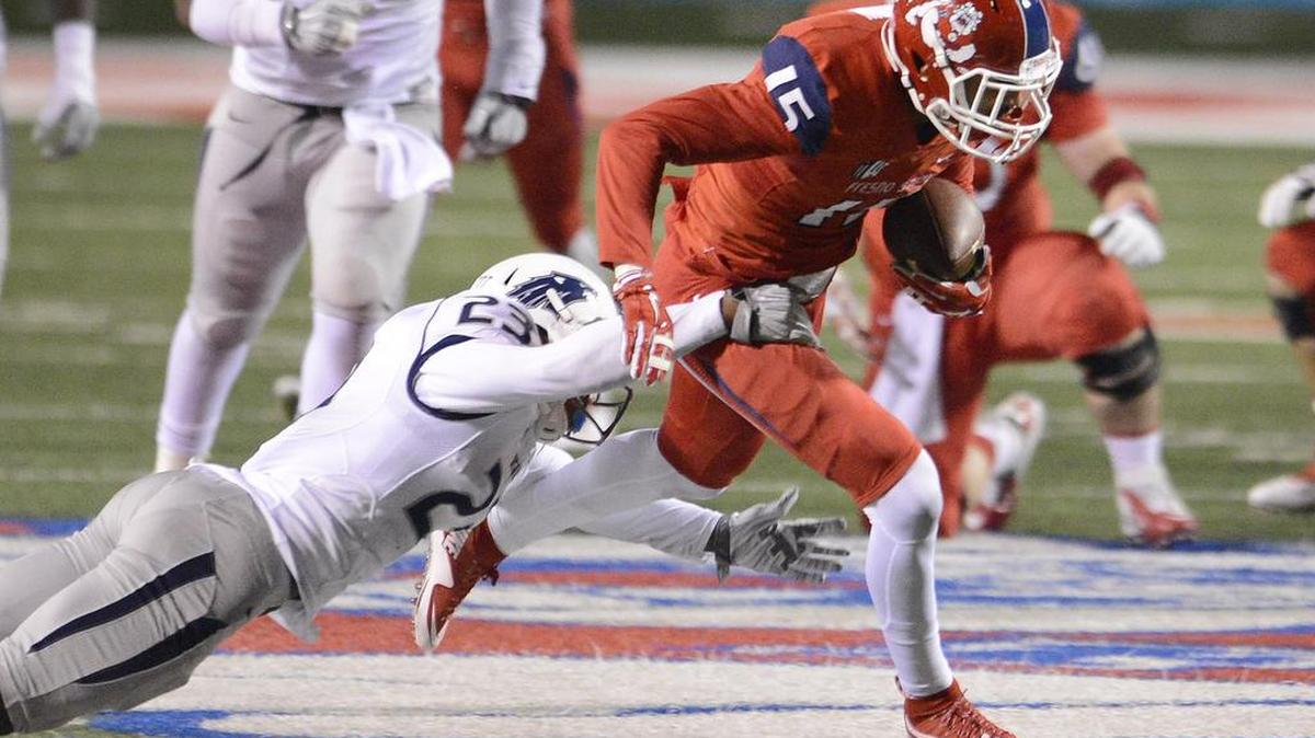 Fresno State’s Josiah Blandin runs with the football after making a catch while defended by Nevada’s Dameon Baber at Bulldog Stadium on Nov. 5, 2015. Blandin is leaving the Bulldogs as a graduate transfer.
