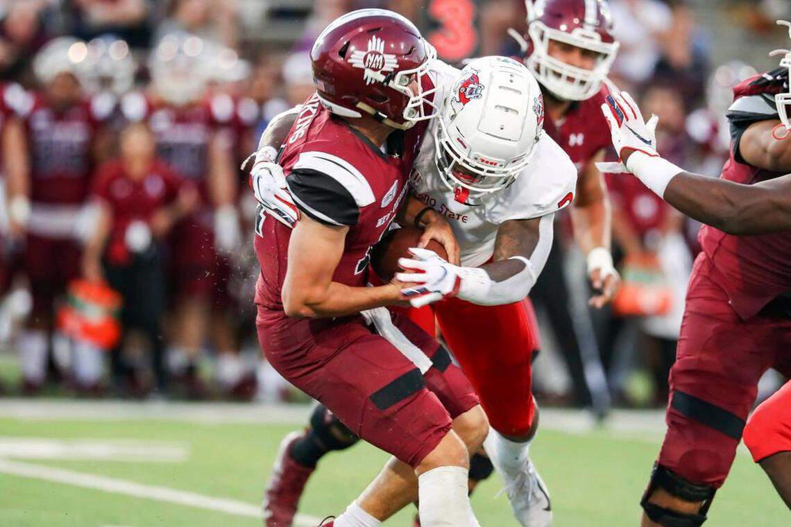 Fresno State’s Mykal Walker sacks New Mexico State quarterback Josh Adkins as the Bulldogs won 30-17 on Saturday. Fresno State finished with two sacks and recorded three interceptions.