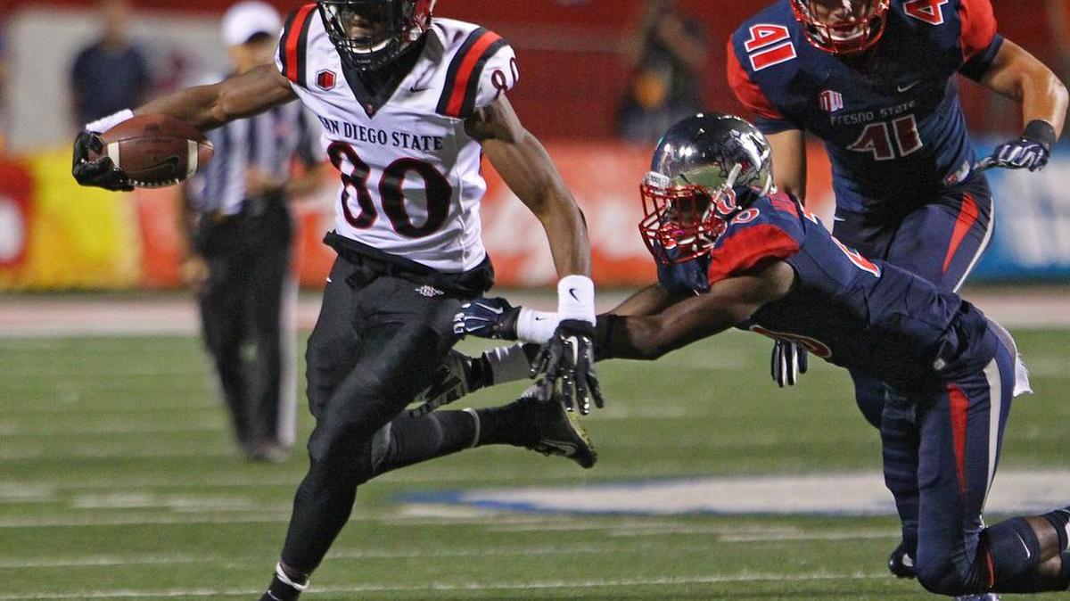 
San Diego State’s Larry Clark slips by Fresno State’s Malcolm Washington during their game in 2014 at Bulldog Stadium. Washington a year ago was pushed onto the field and made seven starts as a 165-pound true freshman. This fall he is up to 182 — a stronger, more physical player.
