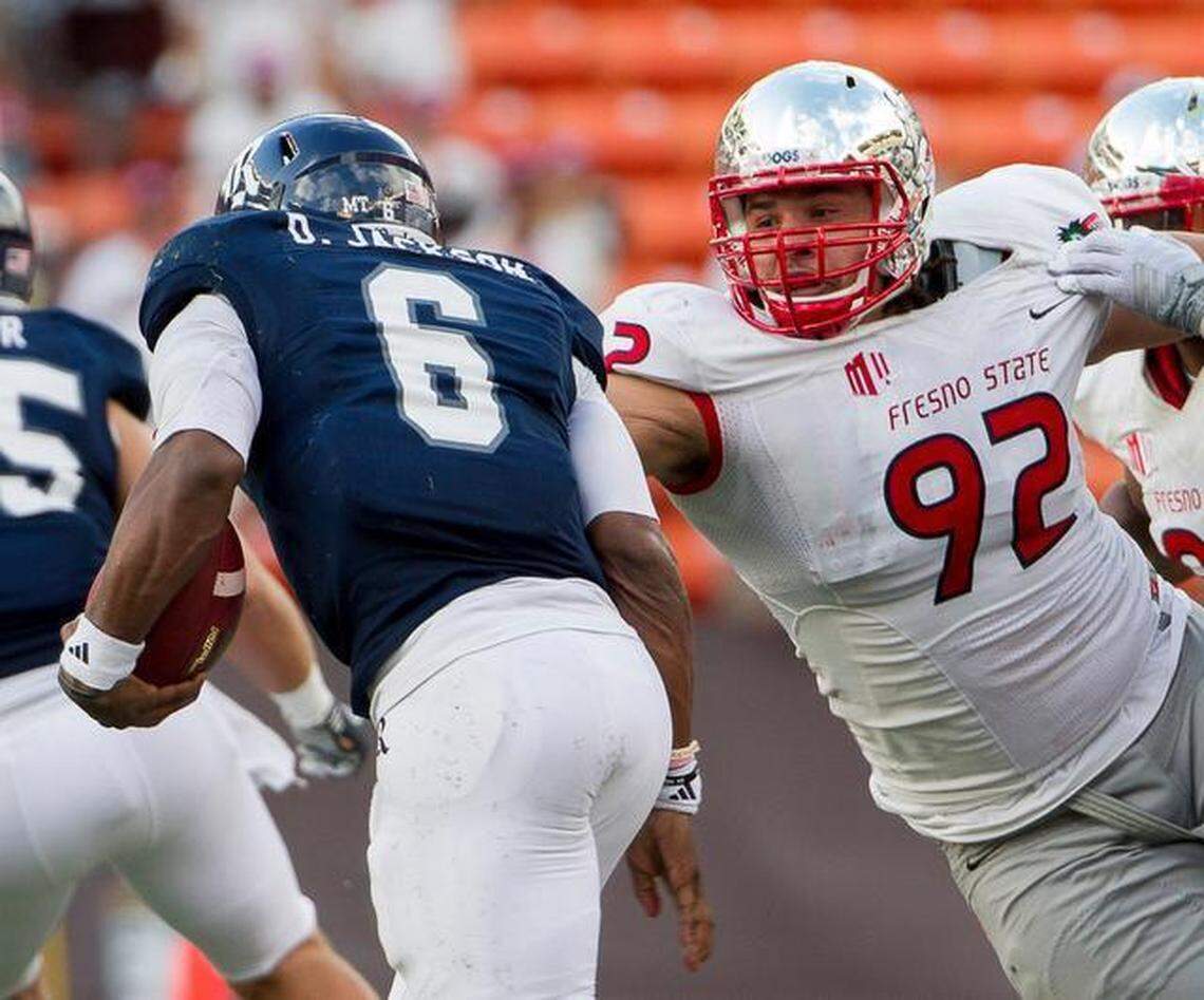 Fresno State defensive lineman Tyeler Davison attempts to take down Rice quarterback Driphus Jackson in the second quarter of the Hawaii Bowl on Dec. 24, 2014, in Honolulu.