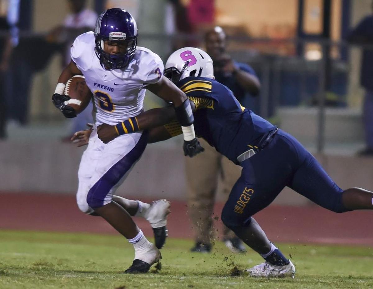 Sunnyside High linebacker Sherwin King, who signed a national letter of intent with Fresno State, tries to take down Fresno High's Khory Day, Friday, Oct. 21, 2016 in Fresno.