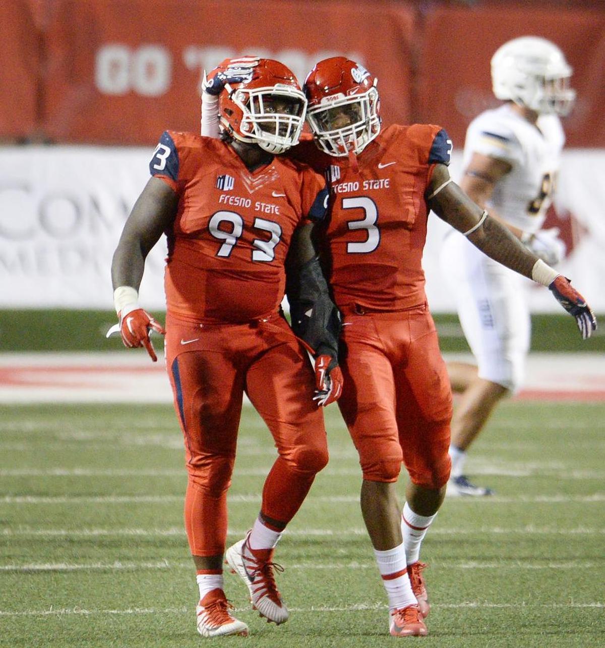 Fresno State defensive tackle Jasad Haynes, left, and defensive end Mykal Walker celebrate a second half sack in a 49-27 victory over Toledo.