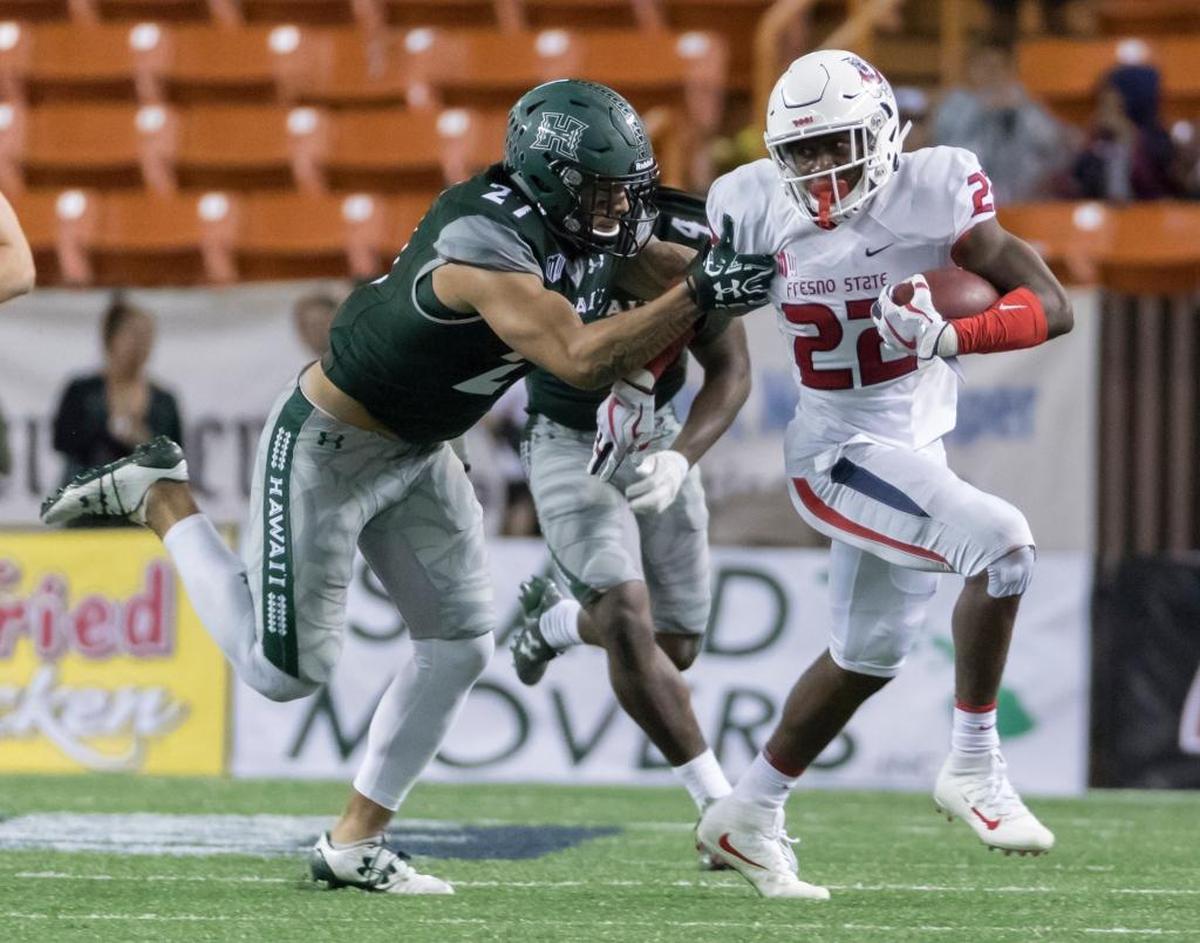 Fresno State running back Jordan Mims (22) attempts to break away from Hawaii linebacker Solomon Matautia (27) during the Bulldogs’ 31-21 victory, Saturday, Nov. 11, 2017, in Honolulu. Mims is the Bulldogs’ leading rushers, averaging 4.5 yards per play and 51.2 yards per game.