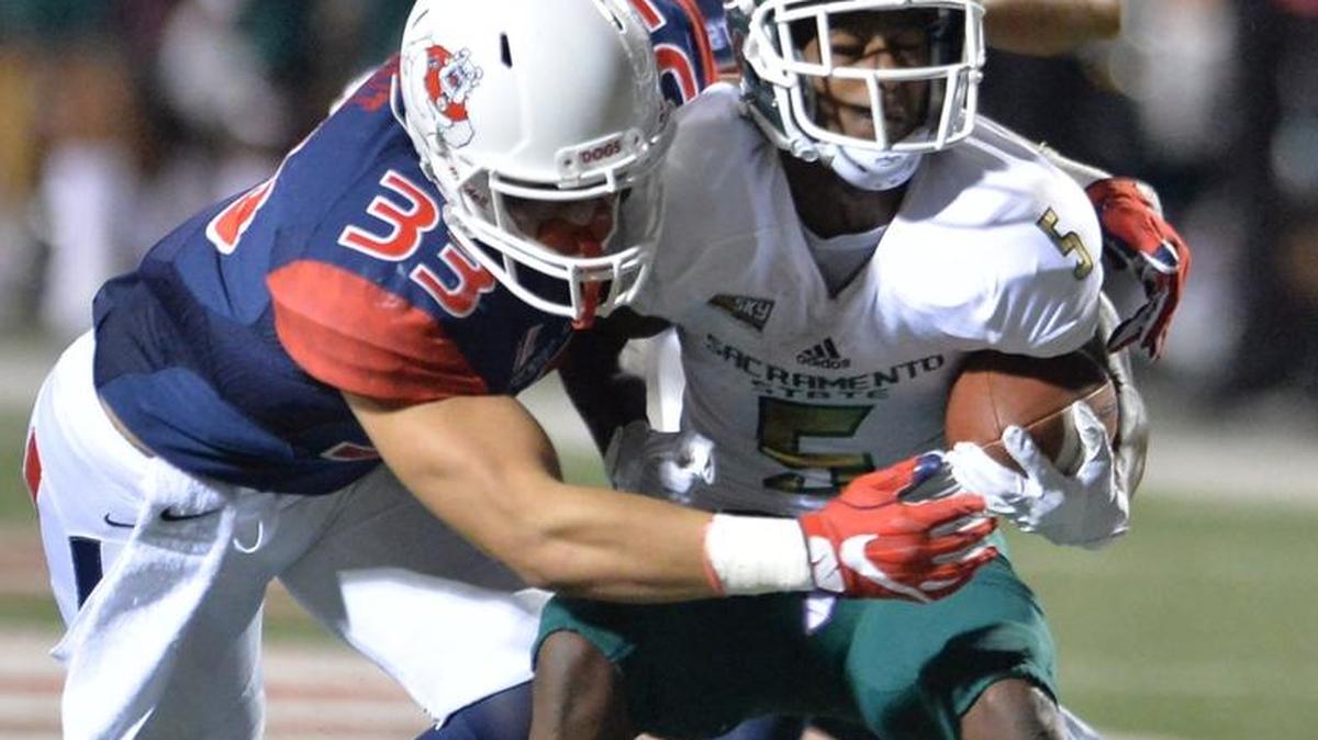 Fresno State freshman linebacker Josh Hokit, left, tackles Sacramento State's Isiah Hennie in the Bulldogs’ home opener at on Saturday, Sept. 10, 2016 in Fresno. Hokit has been in on seven tackles this season including five solo.