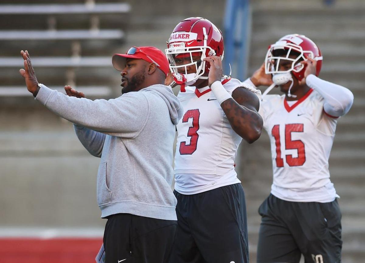 Fresno State linebacker Mykal Walker, center, listens to an assistant coach during spring practice Monday morning, March 11, 2019 in Fresno.