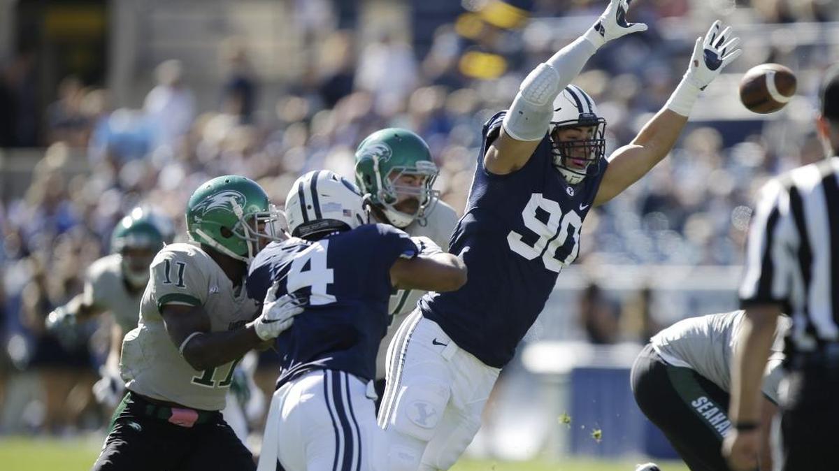 BYU’s 6-foot-8 defensive lineman, Bronson Kaufusi (90), deflects a pass against Wagner in the Cougars’ Oct. 24, 2015 game in Provo, Utah.