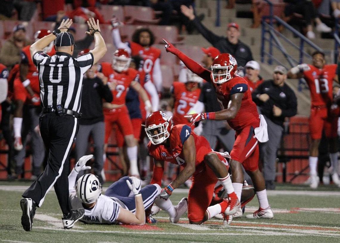 Fresno State safety Mike Bell, center, and James Bailey, right, celebrate a game-clinching fumble recovery by Jeffrey Allison in the Bulldogs’ 20-13 win against BYU at Bulldog Stadium, Saturday, Nov. 4, 2017. Bell separated the football from BYU tight end Matt Bushman with a big hit and the ball popped into the air. Allison raced in to recover the fumble.