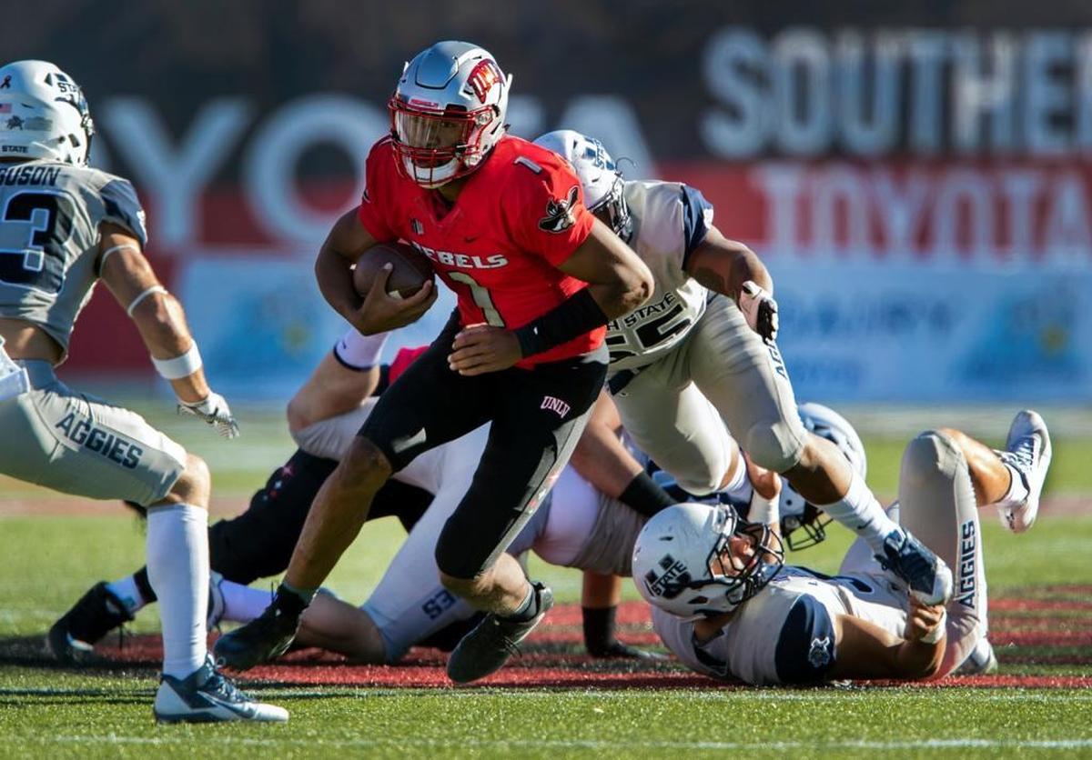 UNLV quarterback Armani Rogers looks for more yardage on a run against Utah State on Oct. 21. Rogers was knocked out of the Rebels’ loss to Utah State in the second quarter with a head injury and has been listed as doubtful to play at Fresno State on Saturday, Oct. 28, 2017.