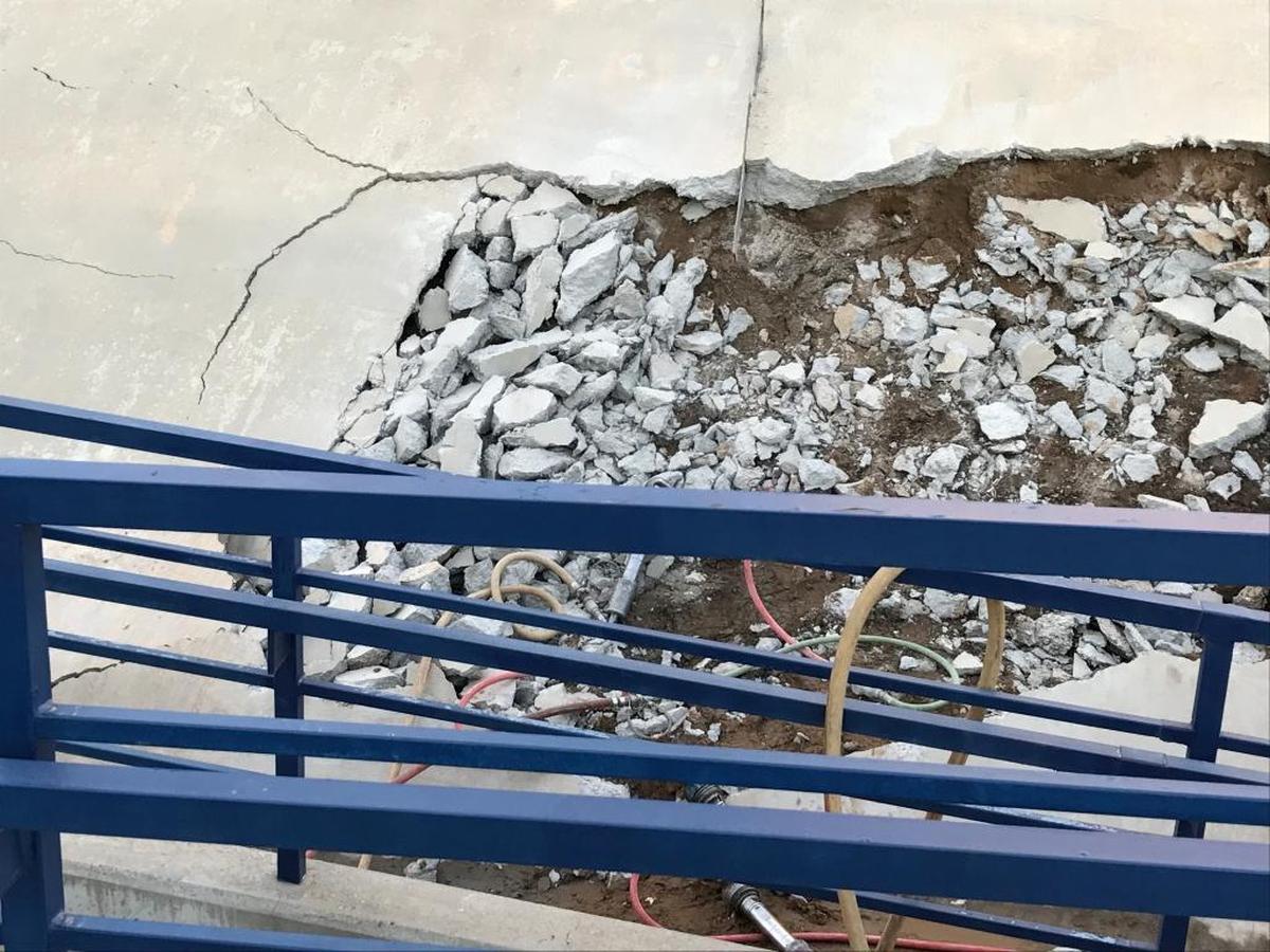 Work crews on Sunday dug through the cement berm on the southeast side of Bulldog Stadium after a broken water line sent mud flowing down the ramp and onto the field. Fresno State will not know the extent of the damage or scope of repair until an engineering assessment is completed on Monday.