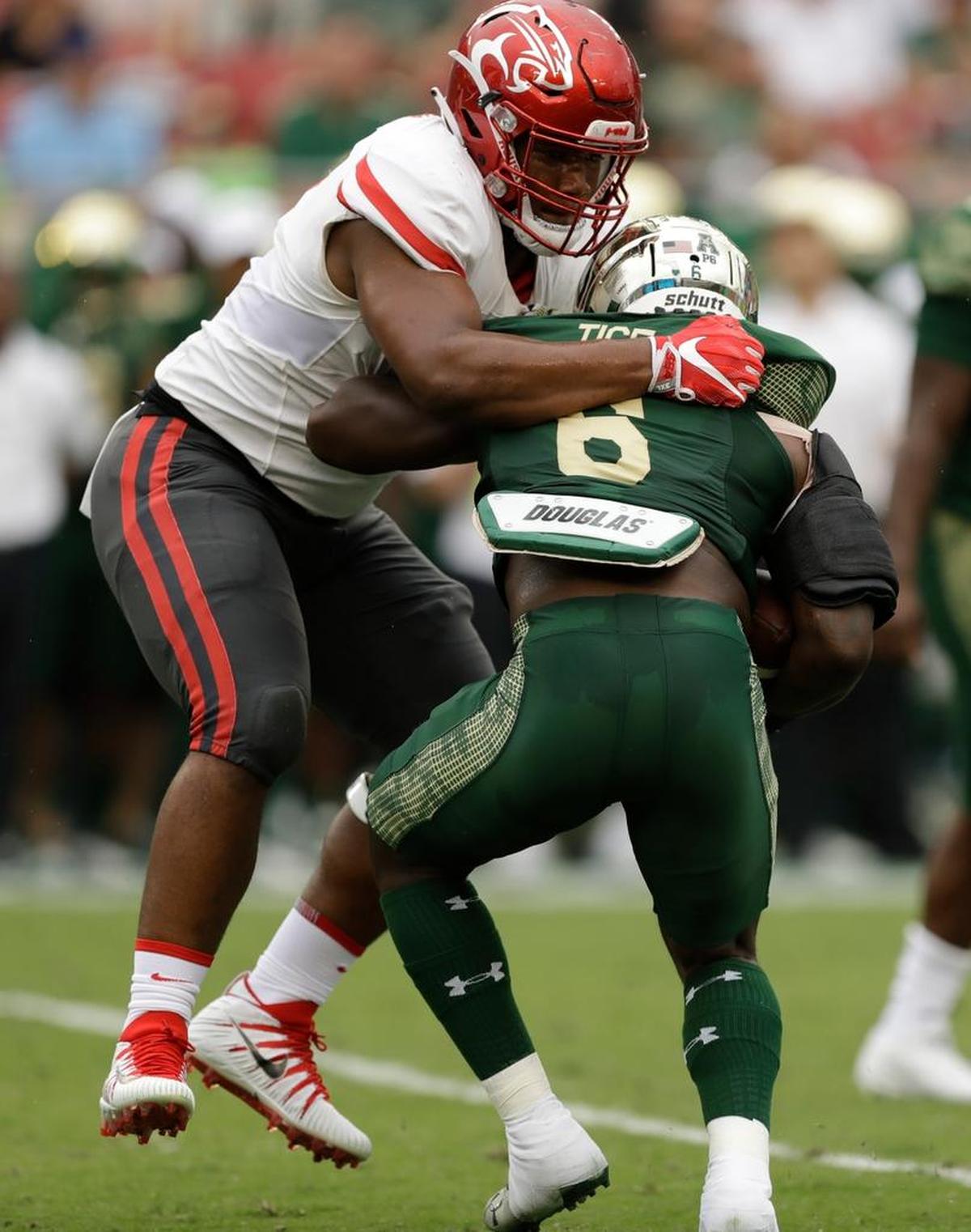 Houston defensive tackle Ed Oliver stops South Florida running back Darius Tice (6) during the first half of the Cougars’ 28-24 viictory, Saturday, Oct. 28, 2017, in Tampa, Fla.