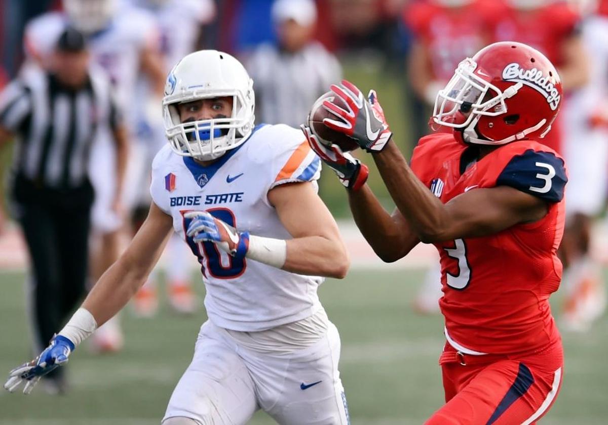 Fresno State wideout KeeSean Johnson pulls in a touchdown pass from Marcus McMaryion while covered by Boise State safety Kekoa Nawahine during the Bulldogs’ 28-17 victory Saturday, Nov. 24, 2017, in Fresno.