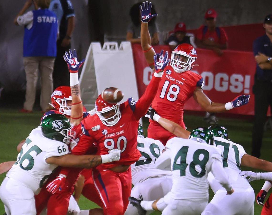 Fresno State’s Kevin Atkins, center. blocks Sacramento State’s Kyle Sentkowski’s field goal attempt Saturday, Sept 21, 2019 in Fresno.