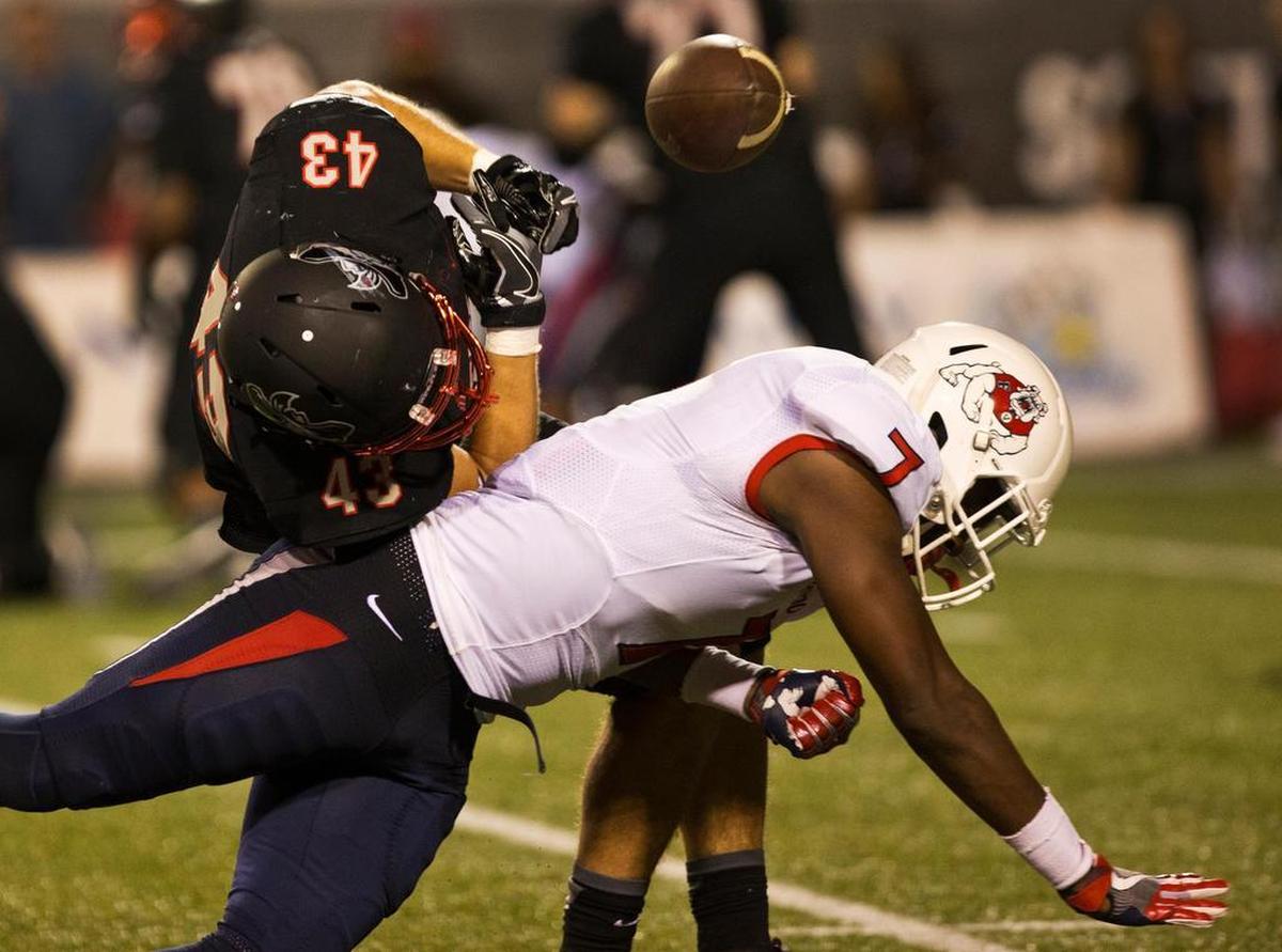 Fresno State linebacker James Bailey (7) separates UNLV's Tim Holt (43) from the football during the Bulldogs’ 45-20 loss to the Rebels Saturday, Oct. 1, 2016, in Las Vegas.