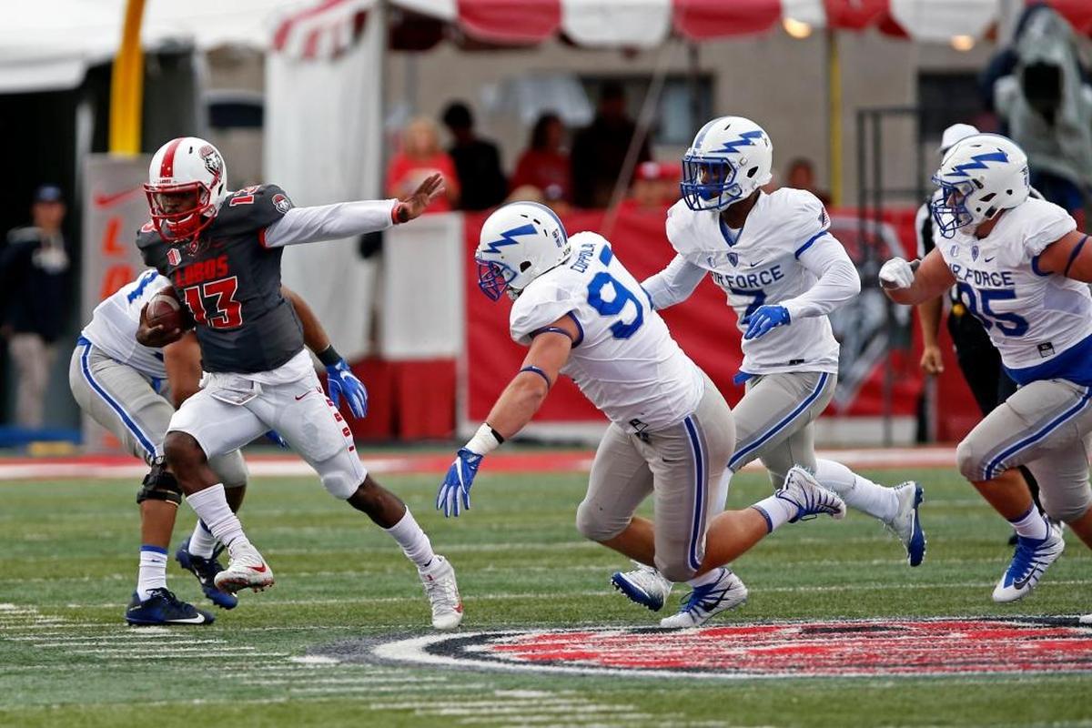 New Mexico quarterback Lamar Jordan (13) rips through the Air Force defense during the Lobos’ 56-38 victory at Albuquerque, Saturday, Sep. 30, 2017. Despite missing one game to injury this season, Jordan is leading New Mexico in total offense with 606 yards and 7.9 per play. Jordan, running the Lobos’ option offense, has completed only 55.3 percent of his passes but is averaging 10.1 yards per attempt and has an efficiency rating of 152.58.