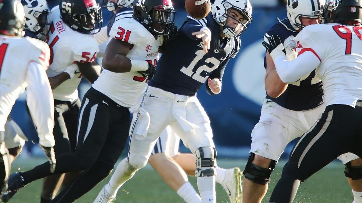 Fresno State’s Ejiro Ederaine (No. 31) pressures BYU quarterback Tanner Mangum on Saturday. Ederaine had one tackle for loss in the game, moving into a tie for second in Mountain West history with 44.0 in his career.
