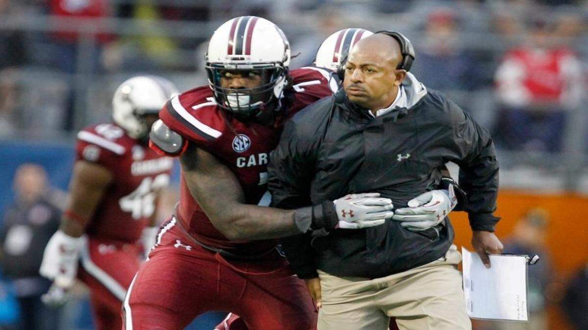 South Carolina defensive end Jadeveon Clowney celebrates with defensive coordinator Lorenzo Ward after a stop on fourth down in the second half of their game against Wisconsin during the Capital One Bowl on Jan. 1, 2014. Ward, after a seven-year run at the position with the Gamecocks, is the new defensive coordinator at Fresno State.