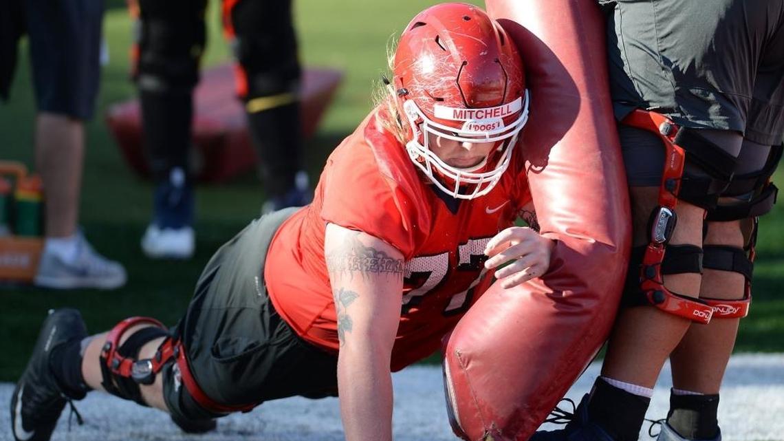 Fresno State center Aaron Mitchell runs through a drill with teammates on the first day of Fresno State spring football practice at Bulldog Stadium on Monday, March 27, 2017, in Fresno. Mitchell will be charged with making the line calls on Saturday against Nevada and its tricky 3-3-5 defense when the Bulldogs open Mountain West Conference play.