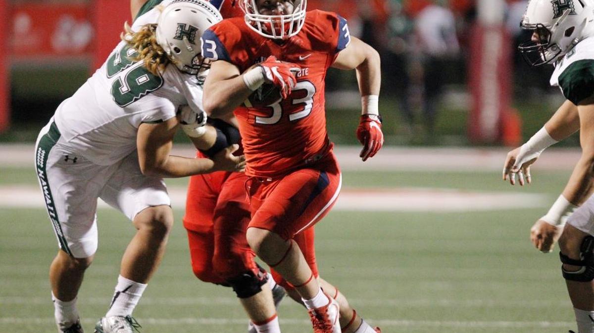 Fresno State running back Josh Hokit eludes a tackle by Hawaii's Zeno Choi in the Bulldogs’ loss last season. Hokit is competing for playing this spring in a crowded group of running backs.