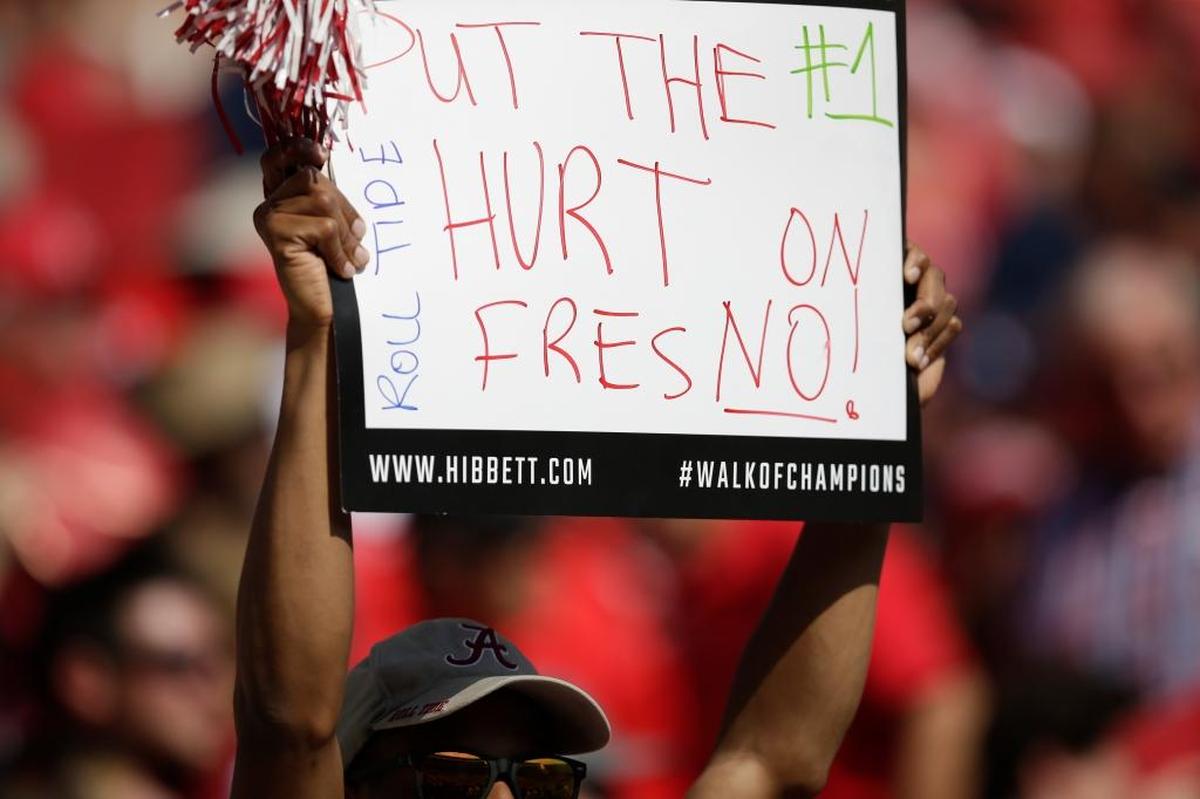 An Alabama fan holds up a sign reading “Put the Hurt on FresNO” in the first half Saturday, Sept. 9, 2017, against Fresno State in Tuscaloosa, Ala. A crowd of 101,127 saw the top-ranked Crimson Tide beat the Bulldogs 41-10.
