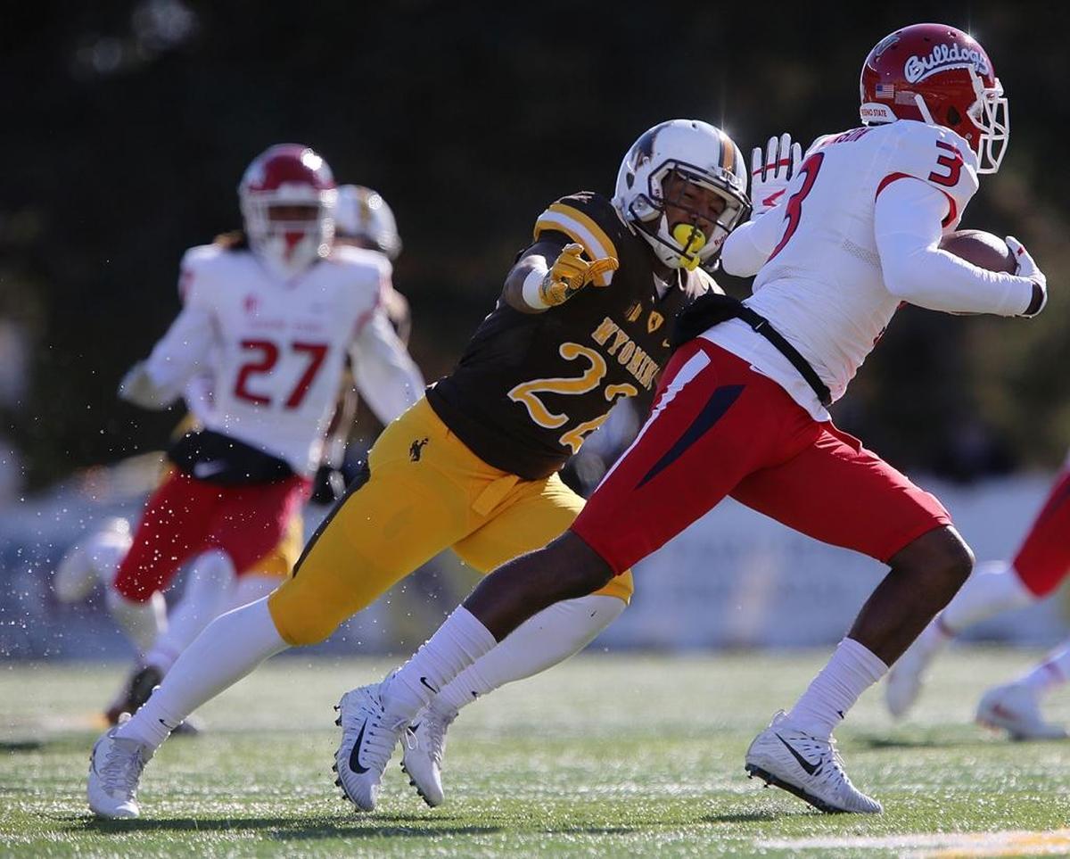 Fresno State wideout KeeSean Johnson tries to escape the grasp of Wyoming cornerback Sidney Washington Jr. in the Bulldogs’ 13-7 victory over the Cowboys on Saturday, Nov. 18, 2017. Johnson caught six passes for 48 yards in the victory, which clinched a West Division title and a spot in the Mountain West Conference championship game for the Bulldogs.