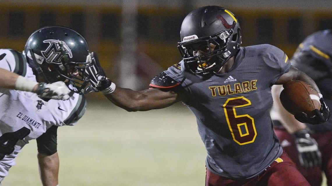 Tulare High’s Romello Harris stiff-arms El Diamante’s Andrew Valdez in an August 2015 game at Bob Mathias Stadium. Harris, after one season at Washington State, announced July 27, 2017, that he plans to transfer to Fresno State.