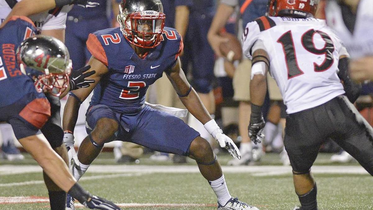 
Fresno State Jamal Ellis, left, looks to tackle San Diego State’s Donnel Pumphrey during their game in October 2014 at Bulldog Stadium. Ellis played in 12 of 14 games last season with four starts and finished with 25 tackles.
