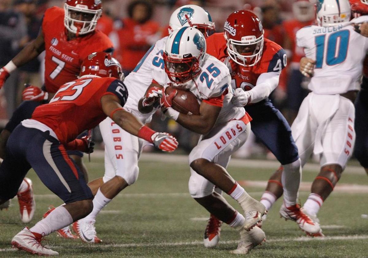 Fresno State safety Juju Hughes (23) and linebacker Justin Green team up to take down New Mexico running back Tyrone Owens in the second half of the Bulldogs’ 38-0 victory on Saturday, Oct. 14, 2017. The Bulldogs are leading the Mountain West in scoring defense, allowing 18.6 points per game and just 12.0 points per game in conference games.