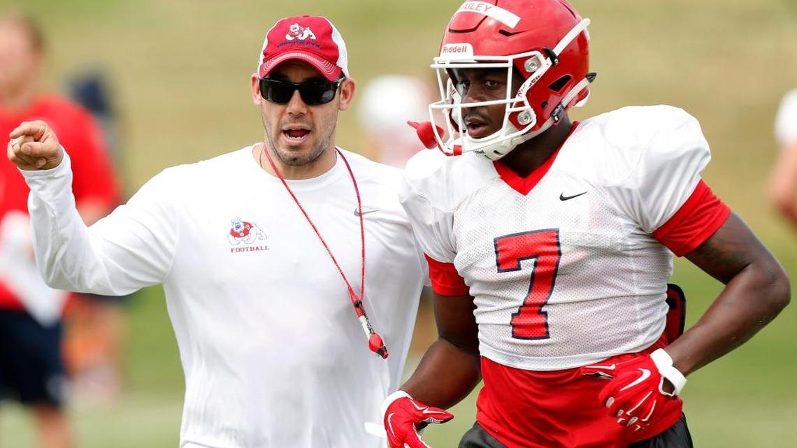 Fresno State defensive coordinator Bert Watts directs outside linebacker James Bailey in a practice during the 2017 season. Watts and the Bulldogs’ staff will be tinkering with their depth at defensive tackle after spring ball looking for different line combinations.