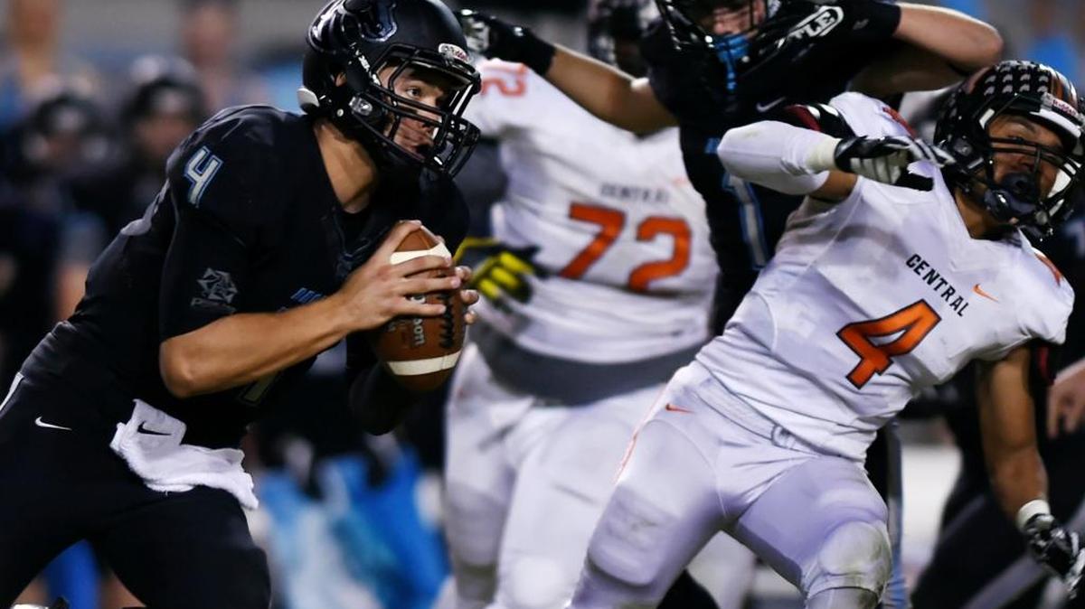 Clovis North quarterback Brent Bailey, left, scrambles for yardage against Central at Veterans Memorial Stadium on Thursday, Oct. 20, 2016 in Clovis.