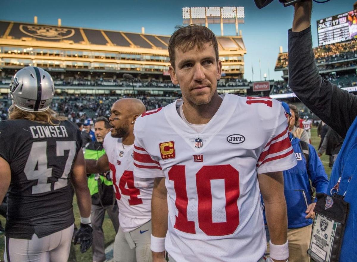 New York Giants quarterback Eli Manning walks off the field after a 24-17 loss to the Oakland Raiders on Sunday, Dec. 3, 2017 in Oakland. Manning was benched by coach Ben McAdoo after 210 consecutive starts for the Giants.