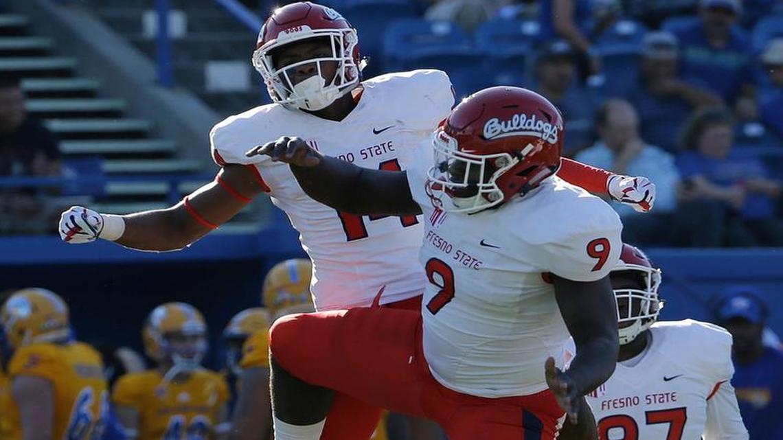 Fresno State defensive back Jaron Bryant, top, celebrates after intercepting a pass against San Jose State with linebacker Jeffrey Allison during the first half Saturday, Oct. 7, 2017. The interception was the third this season for Bryant and one of four turnovers forced by the Bulldogs in a 27-10 victory over the Spartans.