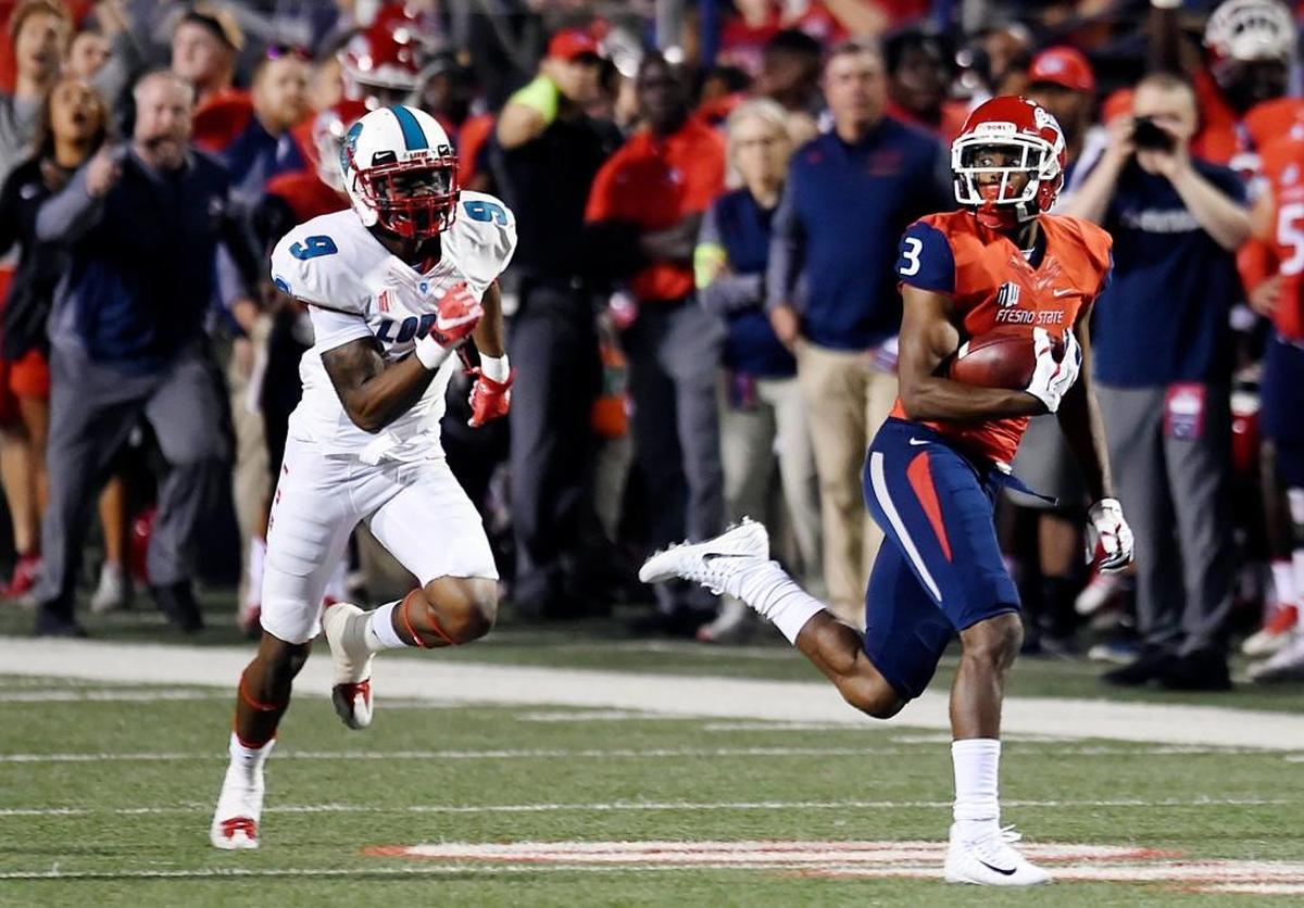 Fresno State wideout KeeSean Johnson races away from New Mexico’s Stanley Barnwell, Jr., left, after a catch and run for a touchdown in first half of the Bulldogs’ 38-0 victory Saturday, Oct. 14, 2017 in Fresno. Johnson, the Bulldogs’ leading receiver, is tied for fifth in the Mountain West Conference with 5.1 receptions per game.