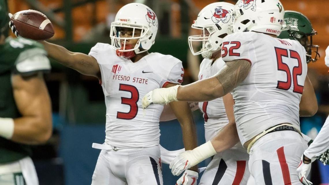 Fresno State wide receiver KeeSean Johnson celebrates with his teammates after taking a screen pass 16 yards for a touchdown in the third quarter of the Bulldogs’ 31-21 victory on Saturday, Nov. 11, 2017, in Honolulu. Johnson caught six passes for 91 yards and two touchdowns in the victory. He now has six touchdown receptions this season.