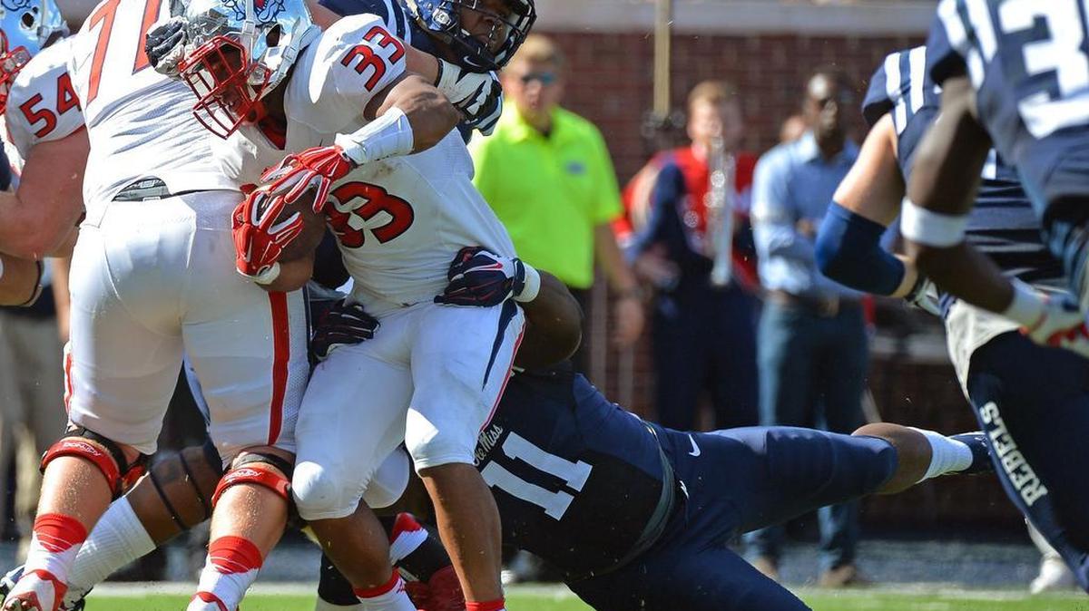 
Mississippi defensive end Channing Ward (11) tackles Fresno State running back Marteze Waller (33) during the first half of Saturday, Sept. 12, 2015. Waller led Fresno State on the ground with 91 yards on a career-high 28 carries, while also adding a receiving touchdown.
