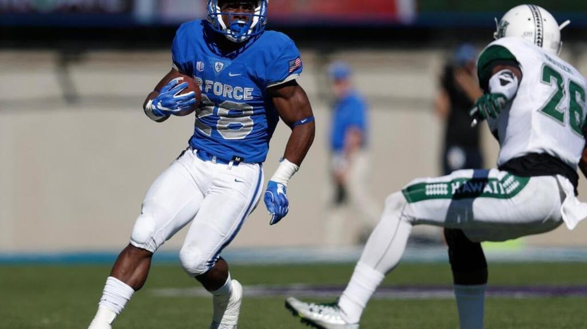 Air Force running back Jacobi Owens takes on Hawaii defensive back Dejaun Butler on Saturday in Colorado Springs, Colo. Owens, averaging 6.7 yards on his 65 carries this season, is one of five Falcons to have rushed for more than 250 yards.