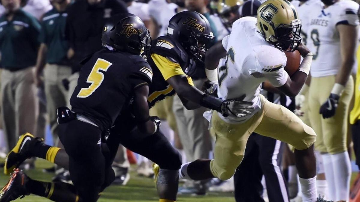Garces’ Chris Coleman, right, is chased by Edison players during their game at Sunnyside High on Sept. 30, 2016. Coleman has given an oral commitment to play for Fresno State and is expected to sign with the Bulldogs on Feb. 1.