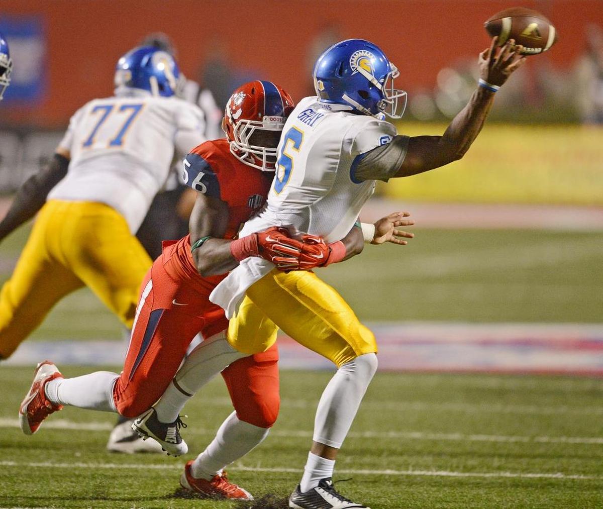 Fresno State defensive end Tobenna Okeke pressures San Jose State quarterback Joe Gray in a 2014 game. Okeke, in his senior season, is second on the team with 9.0 tackles for loss. He will be playing against his hometown team, Houston, in the Hawaii Bowl.