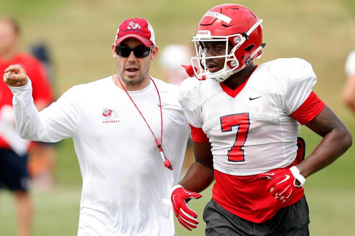 Fresno State defensive coordinator Bert Watts, left, directs linebacker James Bailey in a practice. The Bulldogs’ starting linebackers last season – Jeff Allison, George Helmuth and Bailey – all return and last season ranked first, second and fifth on the team in tackles.
