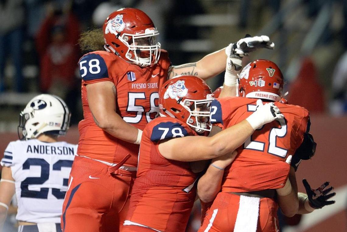 Fresno State running back Jordan Mims (22) is congratulated by teammates Christian Cronk (58) and David Patterson (78) after scoring a touchdown in a 20-13 victory over Brigham Young on Saturday, Nov. 4, 2017, at Bulldog Stadium. Mims led the Bulldogs last season with 627 rushing yards, averaging 4.2 yards per play.
