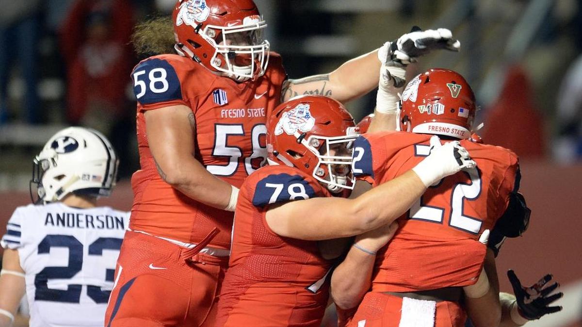 Fresno State running back Jordan Mims (22) is congratulated by teammates Christian Cronk (58) and David Patterson (78) after scoring a touchdown in a 20-13 victory over Brigham Young on Saturday, Nov. 4, 2017, at Bulldog Stadium. Mims led the Bulldogs last season with 627 rushing yards, averaging 4.2 yards per play.