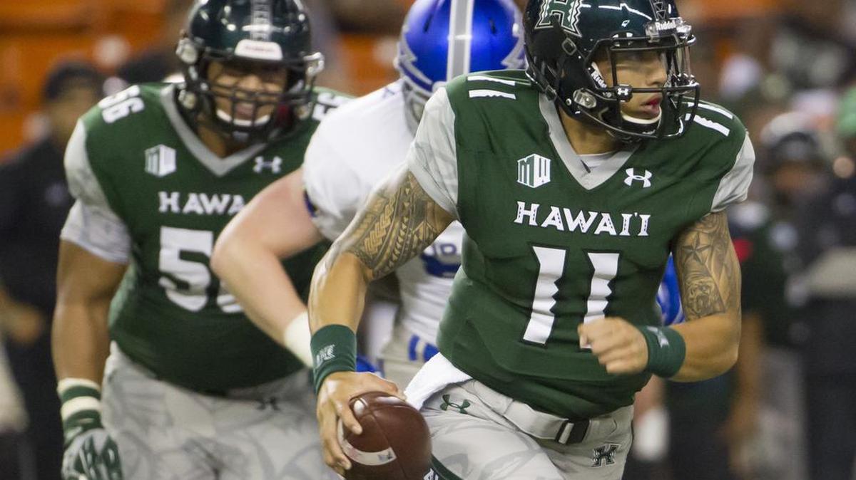 Junior quarterback Ikaika Woolsey (No. 11) adds a run-pass dimension to Hawaii offense that it lacked when senior Max Wittek was flinging footballs around the field.